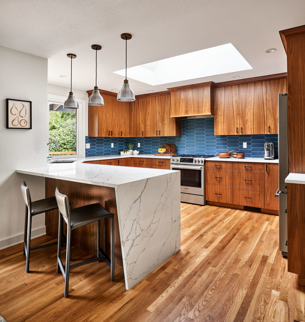 kitchen with walnut cabinets, quartz countertop with angled waterfall