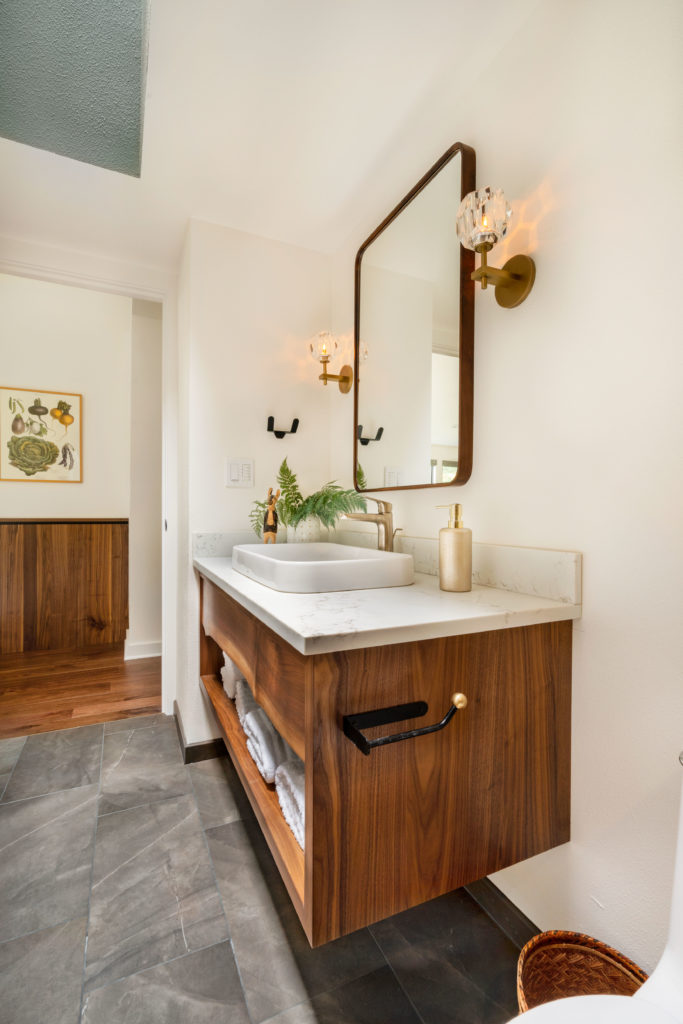 guest bath with walnut live edge vanity, vessel sink, porcelain tile floor, rejuvenation mirror, restoration hardware sconces