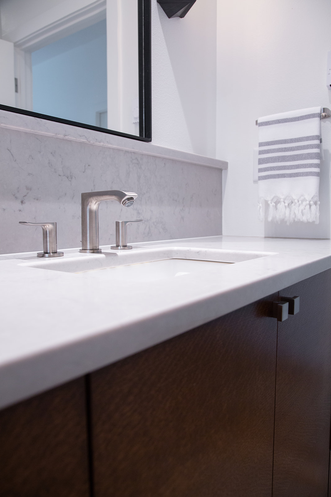 detail shot of the primary bath countertop and framed mirrors