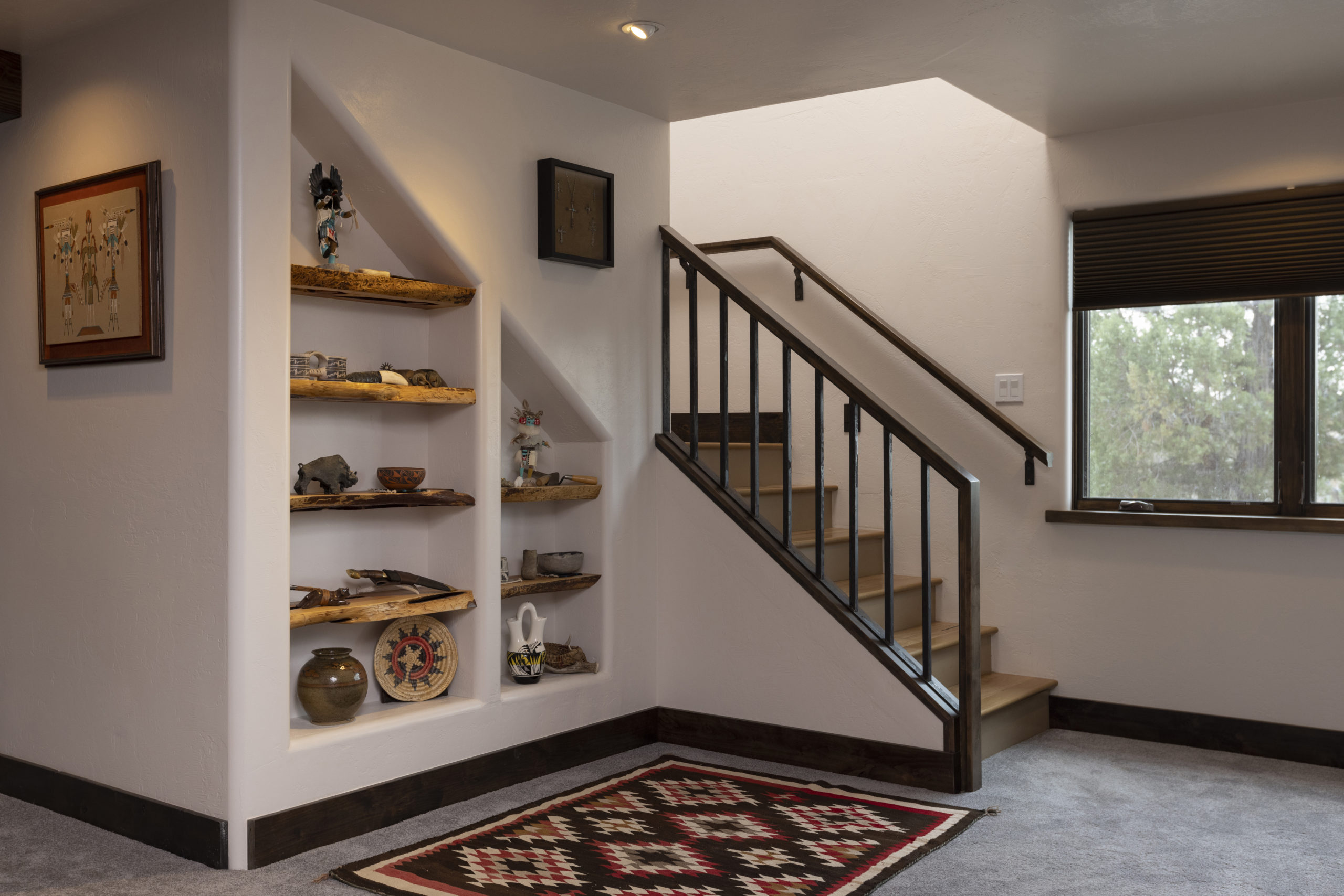 Custom staircase with built in display niches and Navajo rug