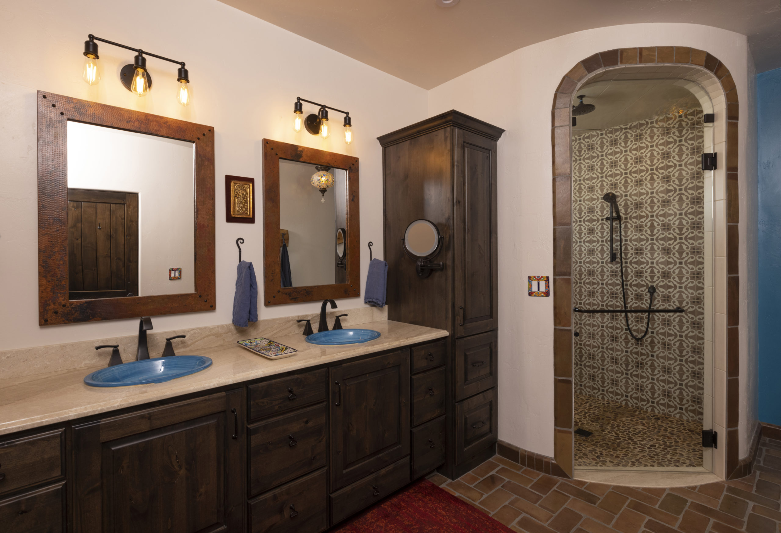 Primary bathroom with arched shower opening, steam shower and custom vanity