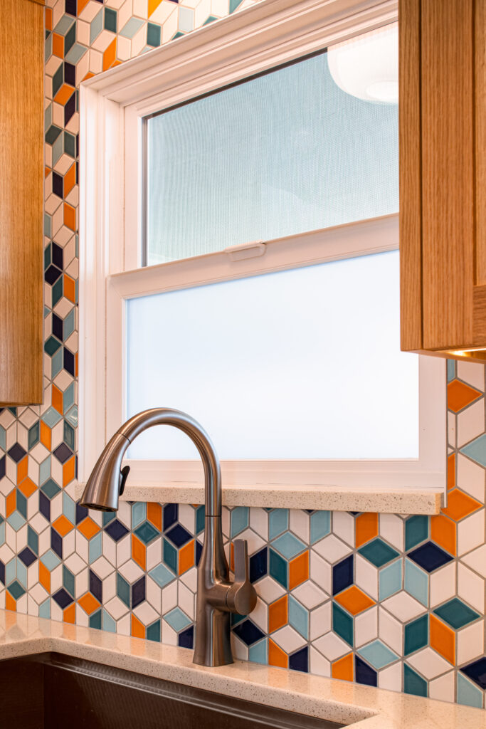 Colorful mosaic backsplash, undermount sink, stainless steel, wood cabinets