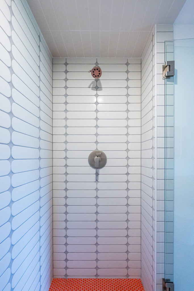 Shower with white oval tile