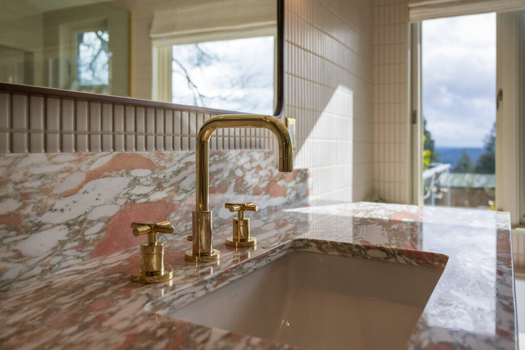 nrowegian rose marble, undermount sink and brass fixtures